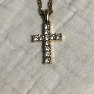 Gold chain necklace with gold cross.